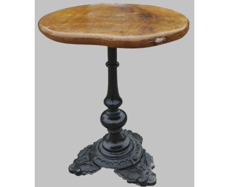 Robert Mouseman Thompson of Kilburn - a bar table, oval figured oak top on slender cast iron baluster column with beaded tref