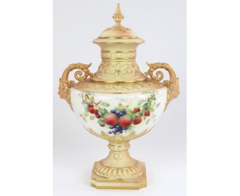 Royal Worcester twin handled pedestal urn and cover, with mask form scrolling handles and reeded square base, the blush ivory