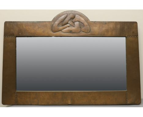 Archibald Knox for Liberty and Co. hammered copper wall mirror, Celtic knot cresting in riveted angular frame, unsigned, 89cm