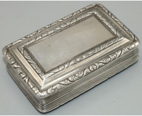 George IV hallmarked silver rectangular table snuff box, with scroll border, reeded sides and engine turned base, gilt interi