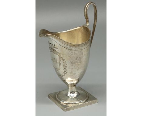 George III hallmarked silver helmet shaped pedestal cream jug, with dot prick and bright cut decoration, initialled cartouche