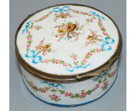 C19th gilt metal mounted white enamel circular box, painted with musical trophies in ribbon tied floral swags, D5.5cm H3.5cm 