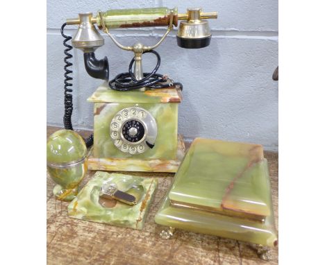 An onyx desk set; telephone, lighter, cigarette box with cigar cutter and ashtray
