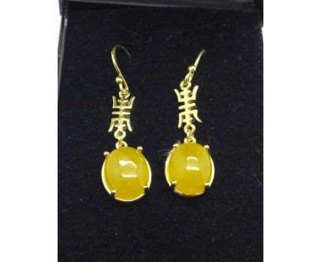 A pair of silver gilt and yellow jade earrings