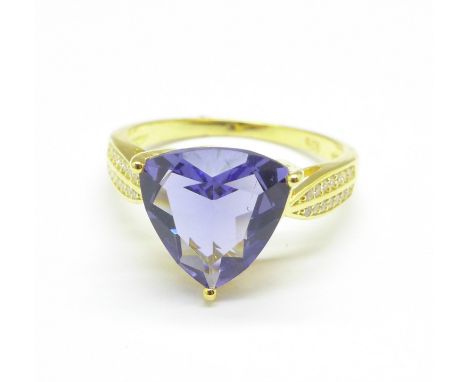 A silver gilt and blue stone ring, R