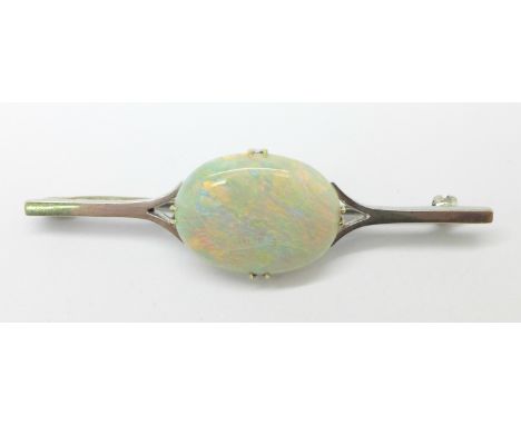 An early 20th Century single stone opal bar brooch, set in white metal, opal 20mm x 14mm, 5.3g, stone cracked