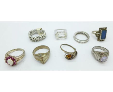 Seven silver rings including one set with opal and rubies, and one other ring, (8)