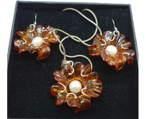 A silver amber and pearl pendant and matching earrings