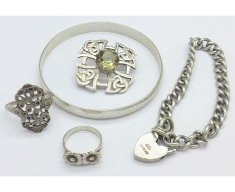A Scottish silver brooch set with citrine, a silver bangle, two silver rings and a white metal bracelet with a sterling silve