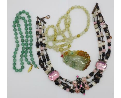 A collection of jewellery including a string of jade beads and carved pendant