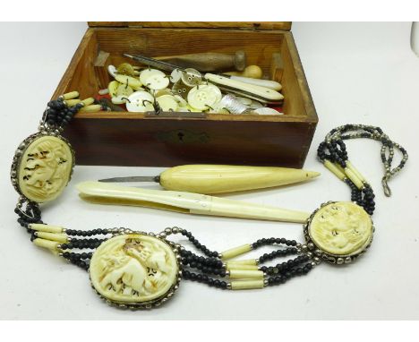 A box containing assorted ivory, bone and mother of pearl items