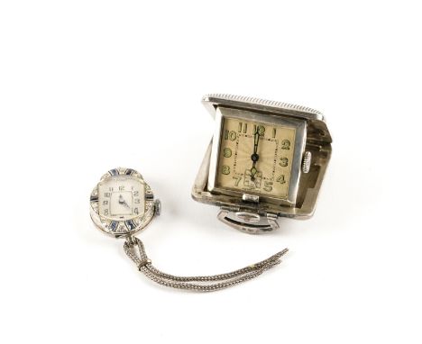 A SILVER CASED TRAVELLING WATCH AND A LADY'S DIAMOND AND BLUE GEM SET DRESS WRISTWATCH (2)The unsigned square silvered dial w