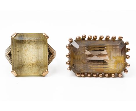 A 9CT GOLD AND CITRINE SINGLE STONE RING AND A GOLD AND SMOKY QUARTZ RING (2)The first claw set with a cut cornered rectangul