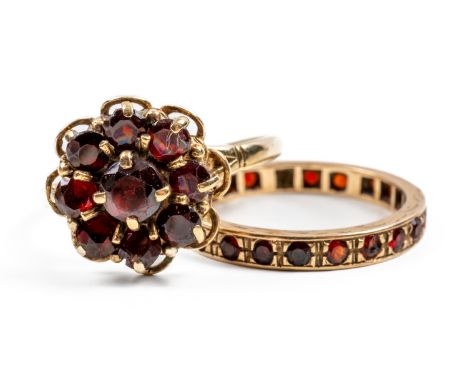 TWO 9CT GOLD AND GARNET RINGS (2)Comprising: a nine stone cluster ring, claw set with round cut garnets, London 1968, ring si