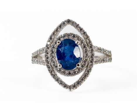 A SILVER NAVETTE SHAPED RINGWith a central claw set oval cut sapphire measuring 6.9mm x 5.3mm, surrounded by two navette shap