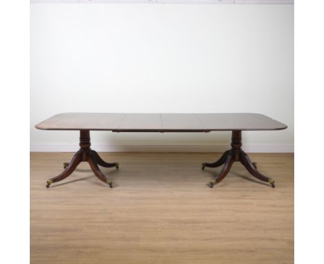 A REGENCY STYLE MAHOGANY TWIN PILLAR EXTENDING DINING TABLEWith two extra leaves, 122cm wide; 197cm long; 295cm long extended