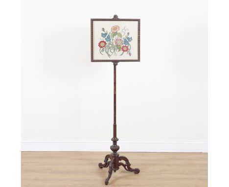 A VICTORIAN ROSEWOOD POLE SCREENWith later needlework panel over tripod base, 51cm wide; 172cm high