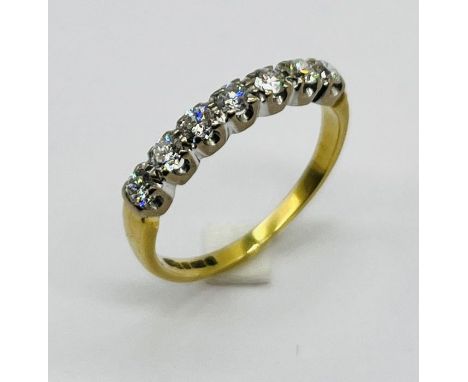 A diamond seven stone half eternity ring set in 18ct gold