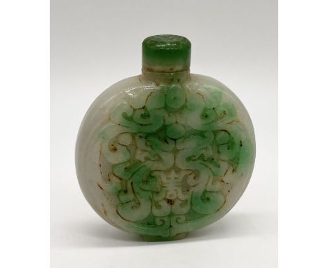 A Chinese jade snuff bottle with carved decoration, height 6.3cm incl. lid