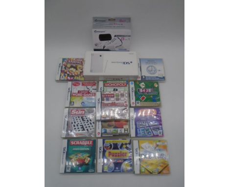 A boxed Nintendo DS console, along with a selection of games and Gamexpert 8 in 1 Essential Pack - untested