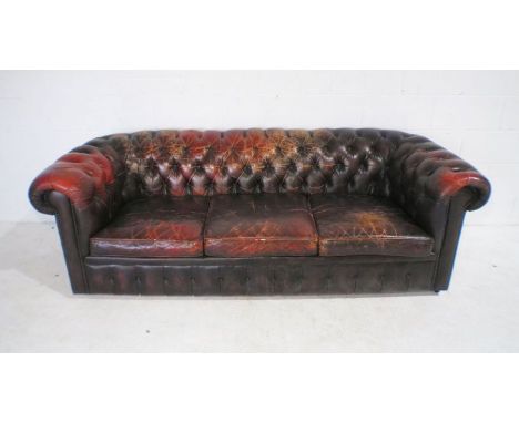 An oxblood leather Chesterfield sofa with button-back detailing, A/F.