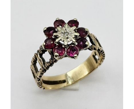 A 9ct gold ring set with rubies and central diamond