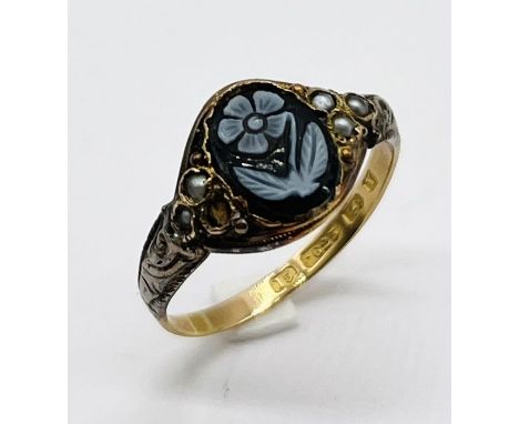 A Victorian 15ct gold ring decorated with cameo style flower and seed pearls (1 missing)