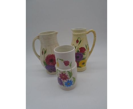 Three pieces of Radford Pottery including two jugs and one vase, all with floral decoration