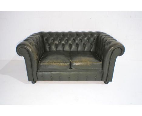 A green leather two seated Chesterfield sofa with button-back detailing, length 147cm.