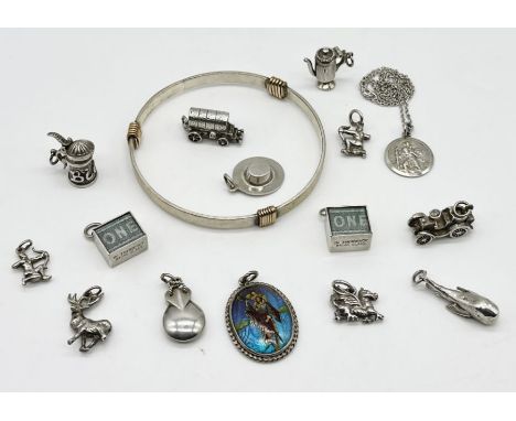 A collection of silver jewellery charms, St Christopher, bangle etc.