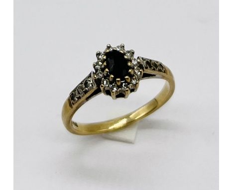 A small sized 9ct gold ring set with sapphire and diamonds