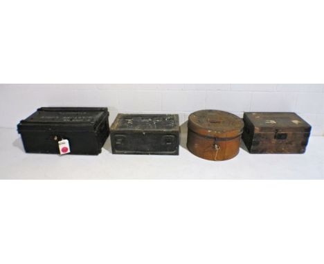 A metal ammo trunk along with another metal trunk, a metal hat tin and a wooden trunk.