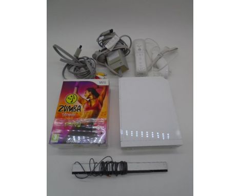An unboxed Nintendo Wii console, along with controller, steering wheel, Mariokart game, power pack, cables, Zumba Fitness gam