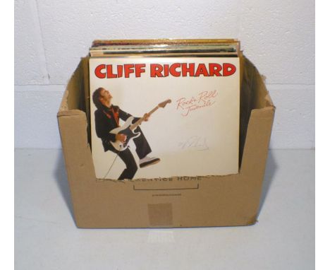 A quantity of 12" vinyl records including a signed Cliff Richard album, Michael Jackson, The Everly Brothers, Simon and Garfu