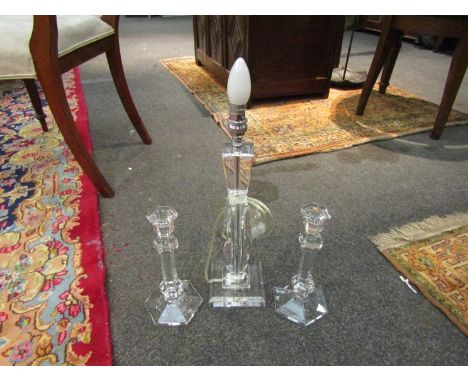 A pair of glass faceted candlesticks and similar lamp