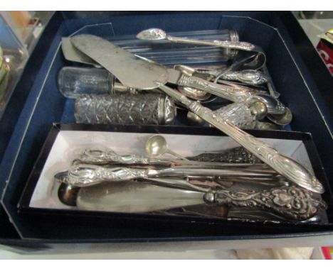 A box containing silver and plated wares including dressing table bottles, glove stretchers, button hooks and flatware 