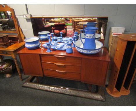 A retro 1960's teak dressing sideboard with mirror back, three drawers flanked by two cabinets