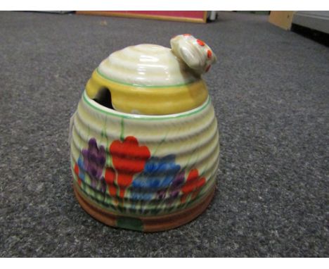A Clarice Cliff "Crocus" pattern honey jar, small chip to lid rim