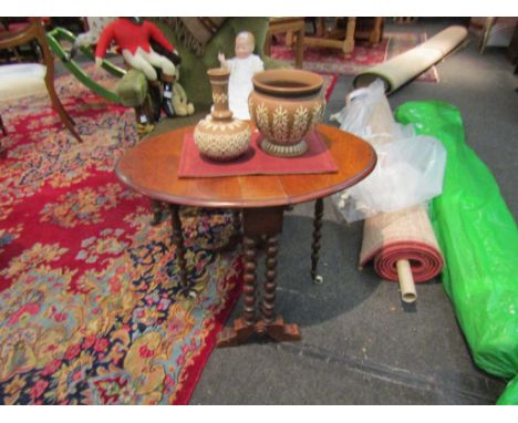 A mahogany Sutherland table on bobbin-turned legs, stretcher, ceramic castors