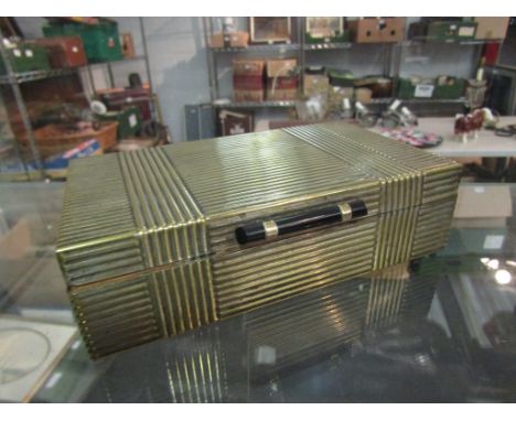 An Art Deco brass cigarette box