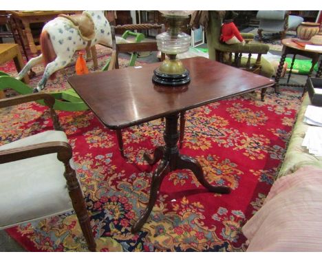 A George III flame mahogany tilt top table on a turned column and tripod legs