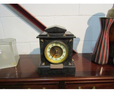 A black slate mantel clock with a brass personal inscription plaque, with key and pendulum 
