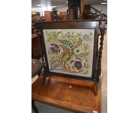 An embroidered fire screen having oak twist frame, height approx. 84cm