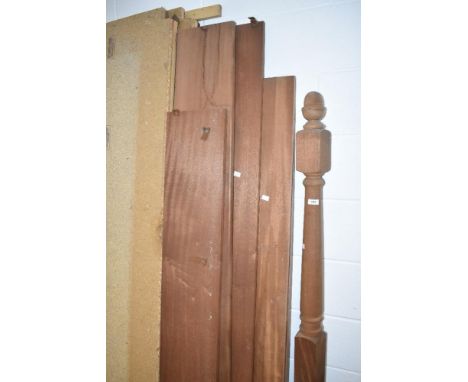 An untreated wooden four poster bed, possibly mahogany , dismantled