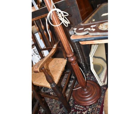 A traditional mahogany standard lamp having fluted column