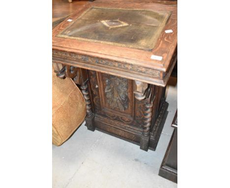 A 19th Oak davenport desk having heavily carved decoration and gallery