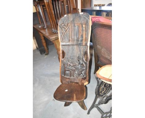 A tribal art carved palaver chair having figural decoration