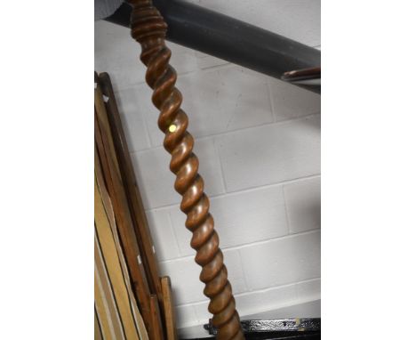 An early 20th Century oak standard lamp having twist column