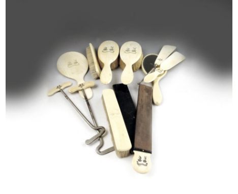 λ Eleven ivory gentleman's toilet items, two hand mirrors, four brushes, a pair of boot-pulls, a button hook, a shoe horn and