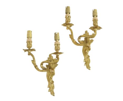 A pair of French ormolu twin light wall appliques in Louis XV style, decorated with scrolling leaves, 29cm high, 21cm wide. (